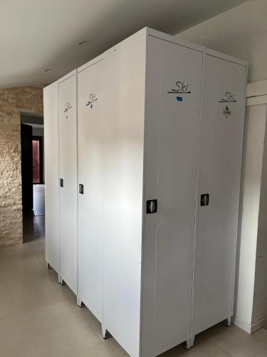 a row of white lockers in a room at Les Erables - 2 chambres 4-6 pers au pied des pistes, WIFI in Péone
