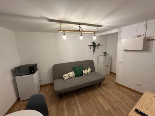 a living room with a couch and a tv at Cantinho das Portas do Sol in Lisbon