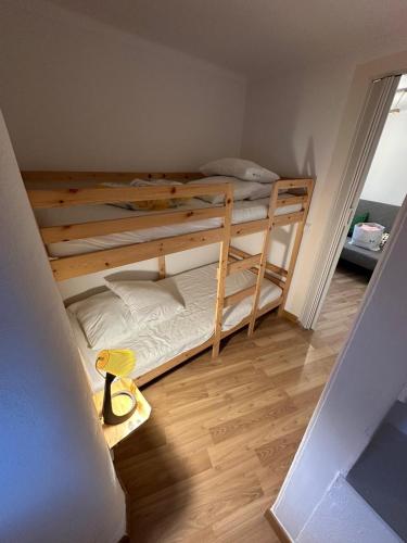 two bunk beds in a small room with a wooden floor at Cantinho das Portas do Sol in Lisbon