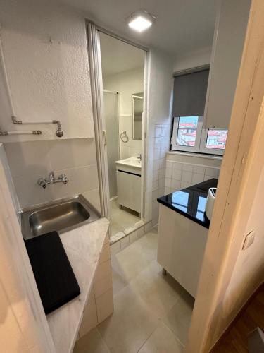 a small bathroom with a sink and a mirror at Cantinho das Portas do Sol in Lisbon