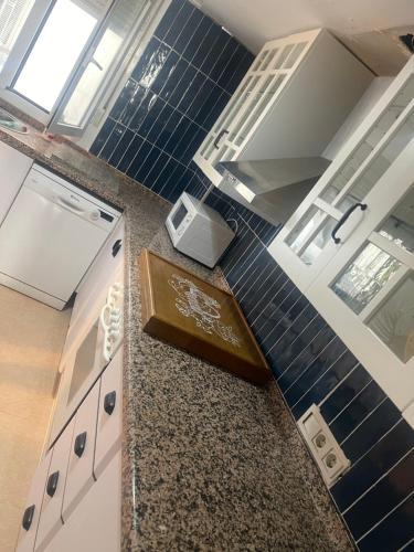 a kitchen with a counter with blue tiles at Altea Beach in Altea