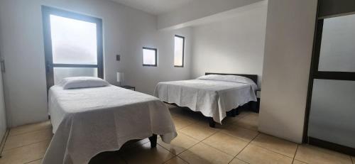 Giường trong phòng chung tại Apart Hotel Azimut Iquique