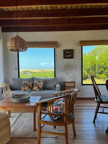a living room with a couch and a table at Casa Grande Punta del Diablo in Punta Del Diablo
