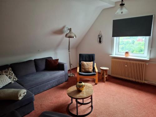 a living room with a couch and a chair at Ferienhaus in Willingen mit eigenem Garten in Willingen
