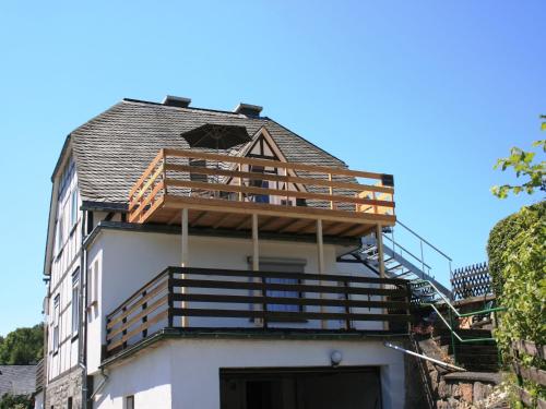 a building with a balcony on top of it at Ferienhaus in Willingen mit eigenem Garten in Willingen