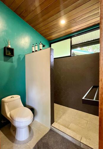 a bathroom with a toilet and a sink at ChicoRico Studios in Uvita