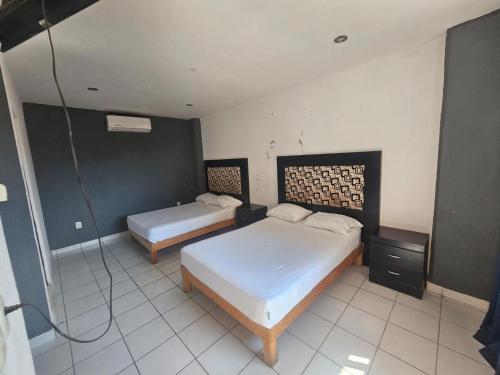 a bedroom with two beds in a room at hotel brisas del pacifico in Puerto Vallarta
