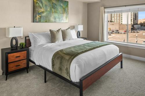 a bedroom with a large bed and a window at Gorgeous 2BD 2BA Pool,Gym,Htub near Convention Ctr in Salt Lake City