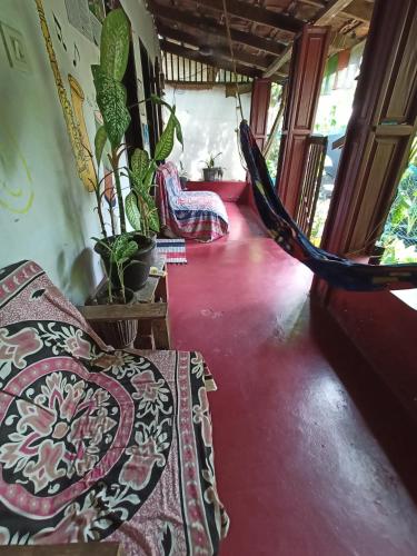 a room with two beds and a hammock at The Blues in Alleppey