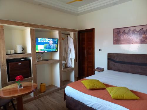 Ein Bett oder Betten in einem Zimmer der Unterkunft Zebra Résidence