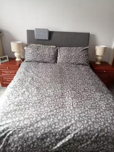a bedroom with a large bed with two night stands at Rooms in historic Bishop Auckland in Bishop Auckland