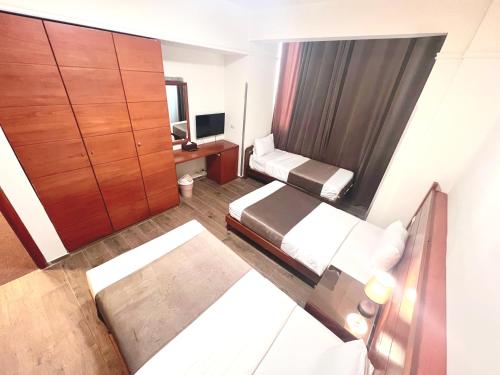 a small room with a bed and a desk at Caesar's Park Hotel in Beirut