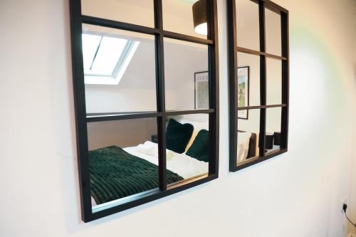 a mirror hanging on a wall in a room at City Centre Retreat Walk To Shops & Dining, Contractors Welcome in Bradford