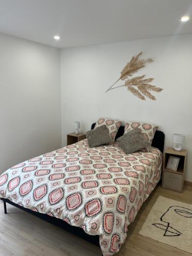 a bedroom with a bed with a comforter on it at Zen Mayar House Toulouse centre in Toulouse