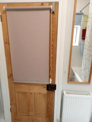 a door in a room with a mirror and a radiator at Rooms in historic Bishop Auckland in Bishop Auckland