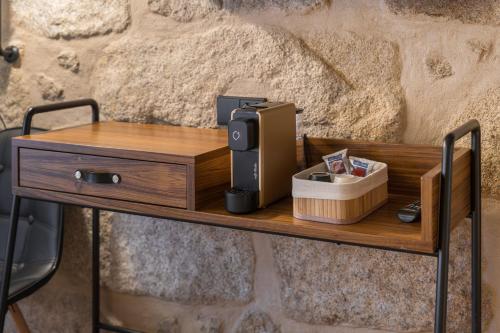 a wooden table with a coffee maker on it at Carpe Diem Porto By Dualgroup in Porto