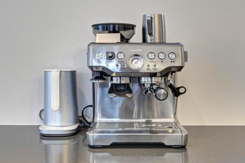 a coffee machine sitting on top of a counter at Modern Luxury 4-Bedroom Home by Mont-Tremblant Ski Resort in Lac-Superieur