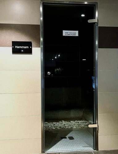 a glass door in a building with a sign on it at Champoussin A'part in Champoussin