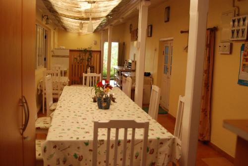 a dining room with a table with flowers on it at Bella Vista Homestay in Coonoor