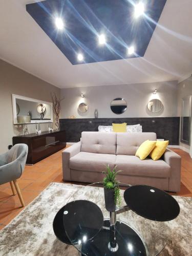 a living room with a couch and a blue ceiling at A Flor da Rosa in Vila Nova de Foz Coa