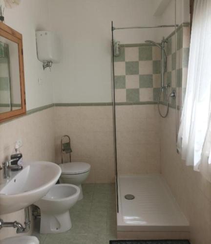 a bathroom with a sink and a toilet and a shower at Affitta camere Via Piave in Foligno