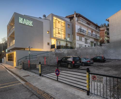a parking lot with cars parked in front of a building at Ark Urban Living in Kozani