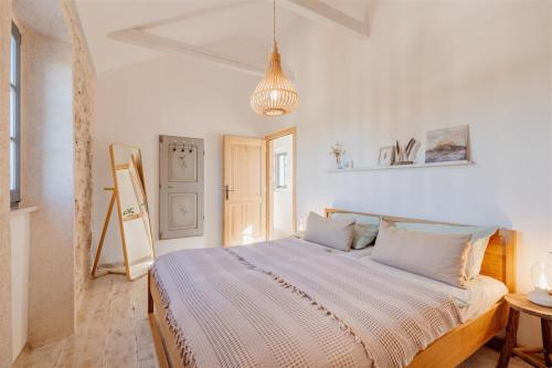 a bedroom with a large bed in a room at Villa pero -an artists home in Ždrelac