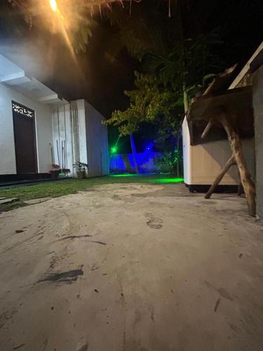 an empty parking lot at night with a building at Nisha Grean Heaven in Weligama