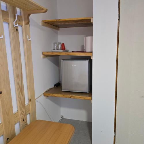 a small tv sitting on a shelf in a room at STD "Vila Bor" Stara planina in Crni Vrh