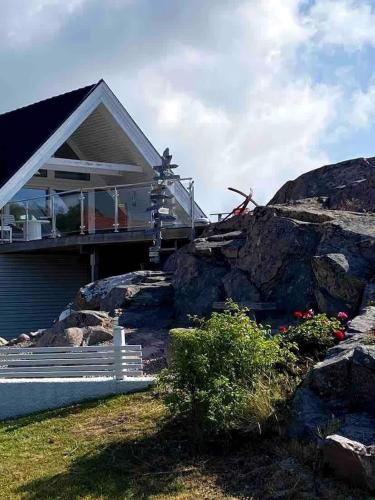 a house sitting on top of a rocky hill at Skalhamn a village seaside in Lysekil