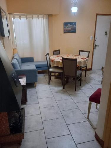 a living room with a table and a couch at Dpto meli in Mar del Plata