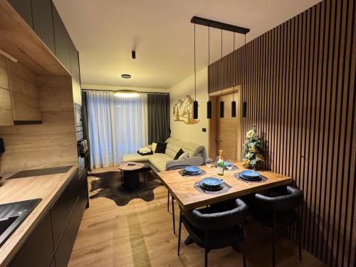 a living room with a table and a couch at Luxury Mountain Apartment in Janske Lazne