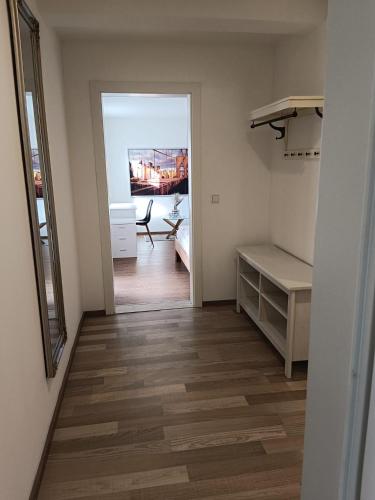 a room with a hallway with a desk and a mirror at Haus Josef, Apartment mit Balkon und 2 Schlafzimmer in Bischofshofen
