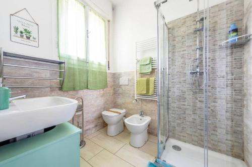 a bathroom with a sink and a toilet and a shower at La finestra sulla fiera in Bologna