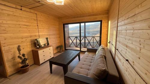 a living room with a couch and a window at Old Byurakan Cottage in Byurakan