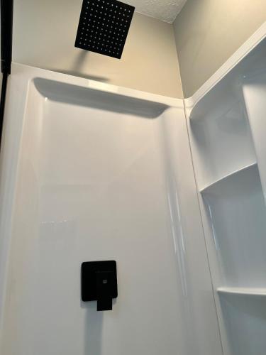 a refrigerator with a speaker on the wall at MidWay Mountain Views in Asheville