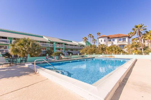 a swimming pool in front of a resort at Wave n Sea - Deep Water Cove 2B Townhome in Pensacola Beach