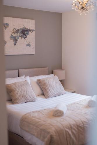 a bedroom with a large bed with a map on the wall at Board Games & Chill Stylish City Apartment in Wolverhampton