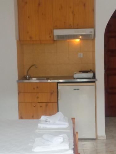 a kitchen with a sink and a counter with towels at George Studios Stalis in Stalida