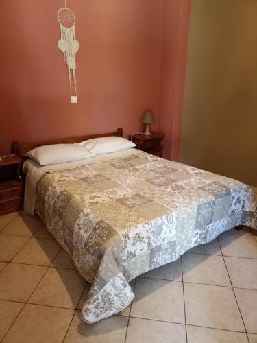 a bedroom with a bed with a cross on the wall at Vegera Apartment M in Vasilikiádhes