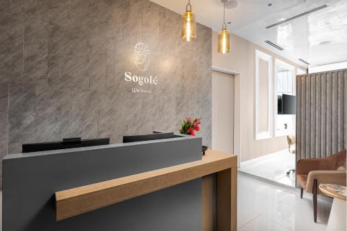 a lobby with a reception desk in a building at The Bickley Park Hotel in Lekki