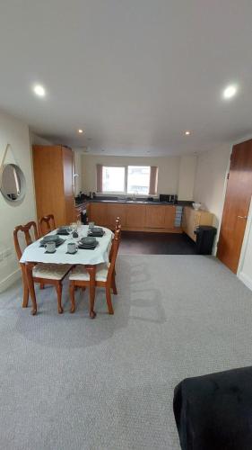 a dining room with a table and chairs in a room at Seaside Serenity in Swansea
