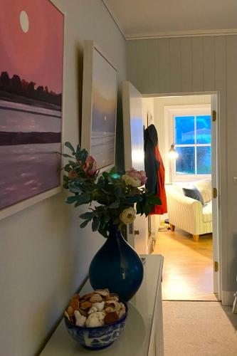 a vase with flowers on a table in a room at NEW Cosy Gem, Near Beach, Log-Burner, Dog Friendly in East Wittering