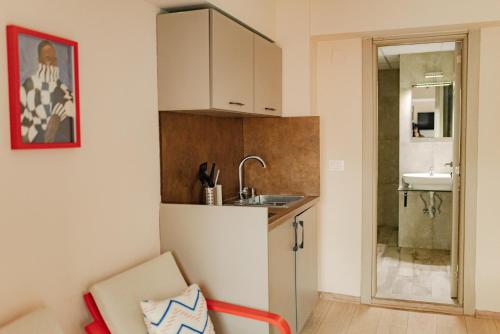 a small kitchen with a sink and a counter at Central Studio Apartments by Parkside Boutique in Skopje