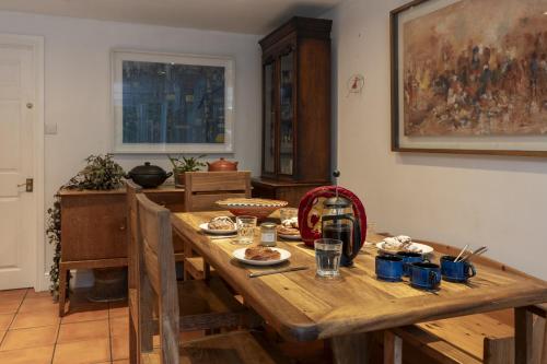 a wooden table with food on it in a room at Sandford Meadow Guest House in Oxford