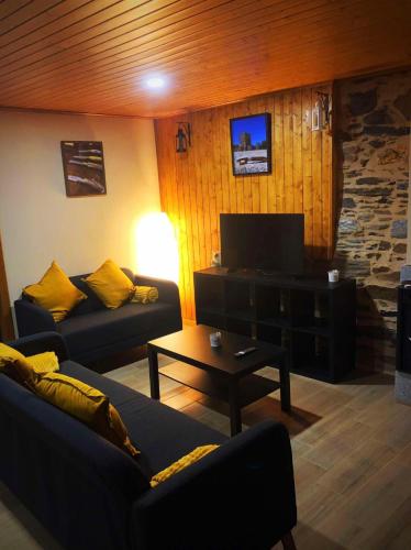 a living room with two couches and a television at Casa do Henrique in Bragança