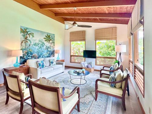 a living room with a couch and a table at Puna Zen Botanical Garden Retreat in Keaau