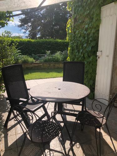 a table and two chairs sitting on a patio at Périgord Escapades in Pineuilh