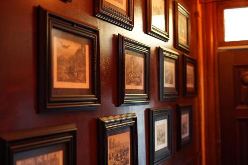 a bunch of framed pictures on a wall at The Rosemary in Los Angeles