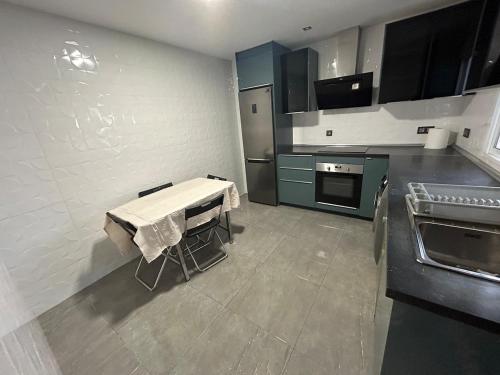 a kitchen with a table in the middle of it at Casa Luque in Málaga